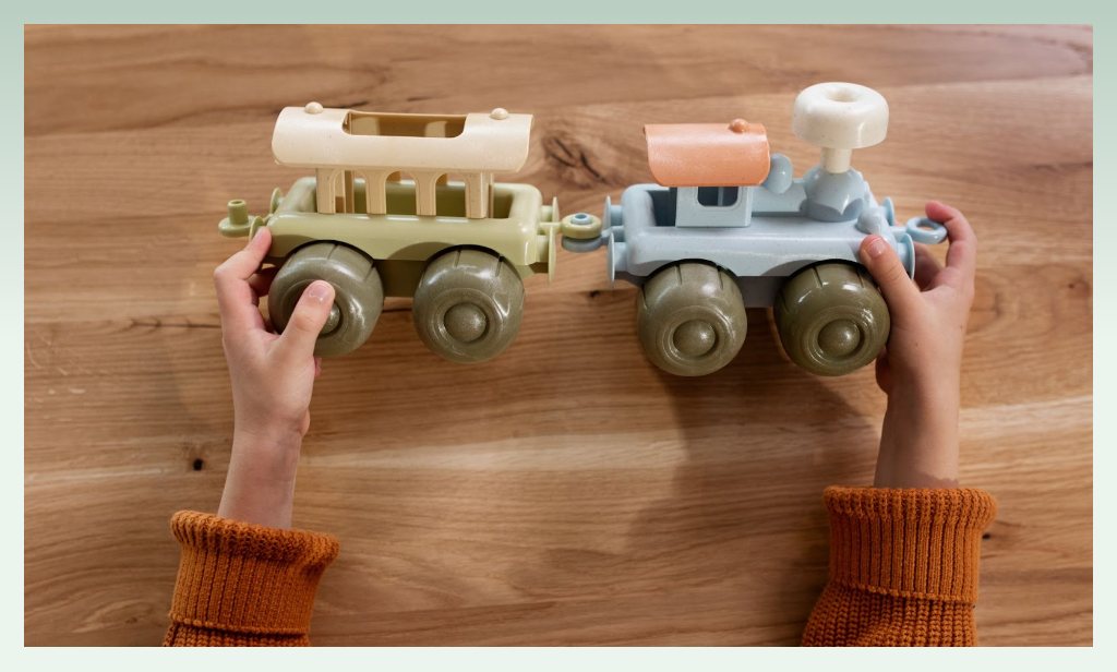 hands-holding-wooden-trains-toys-selling-business